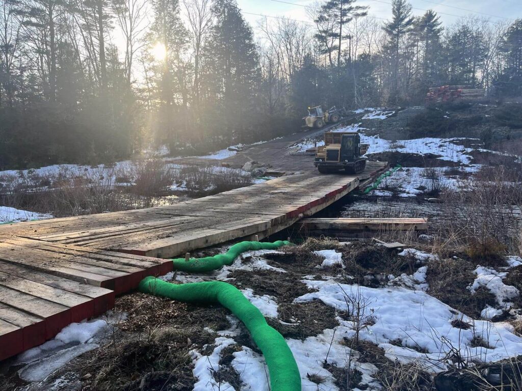swamp mats, timbers and bridge mats create access over a stream