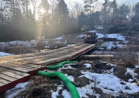 swamp mats, timbers and bridge mats create access over a stream